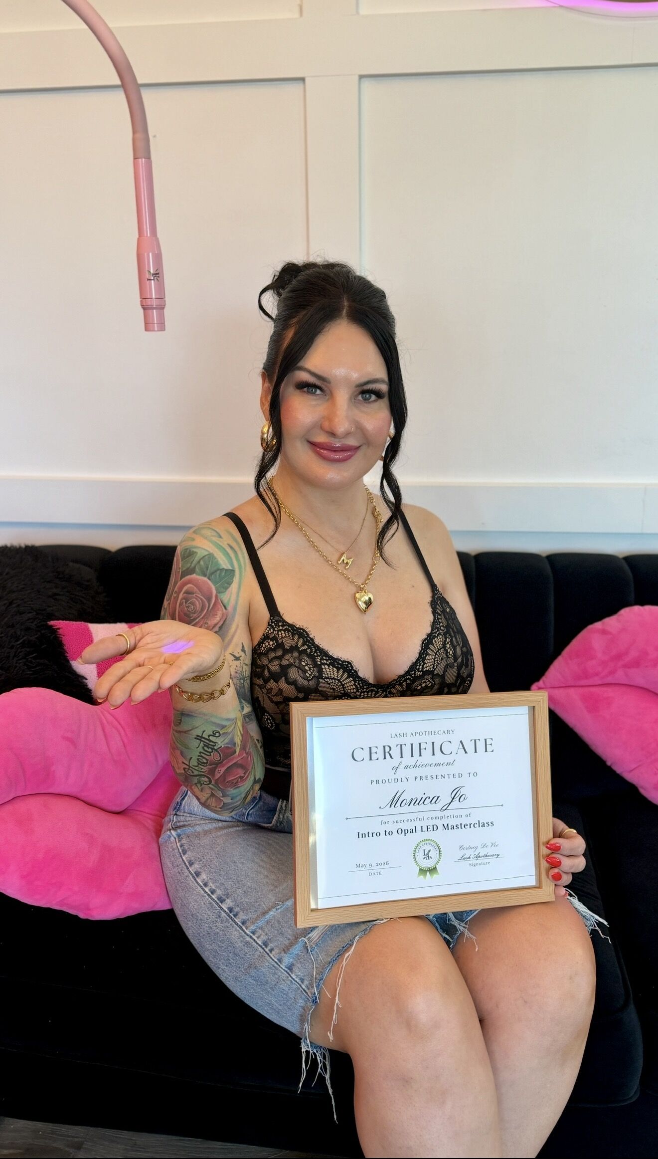 A graduate holding her framed certificate