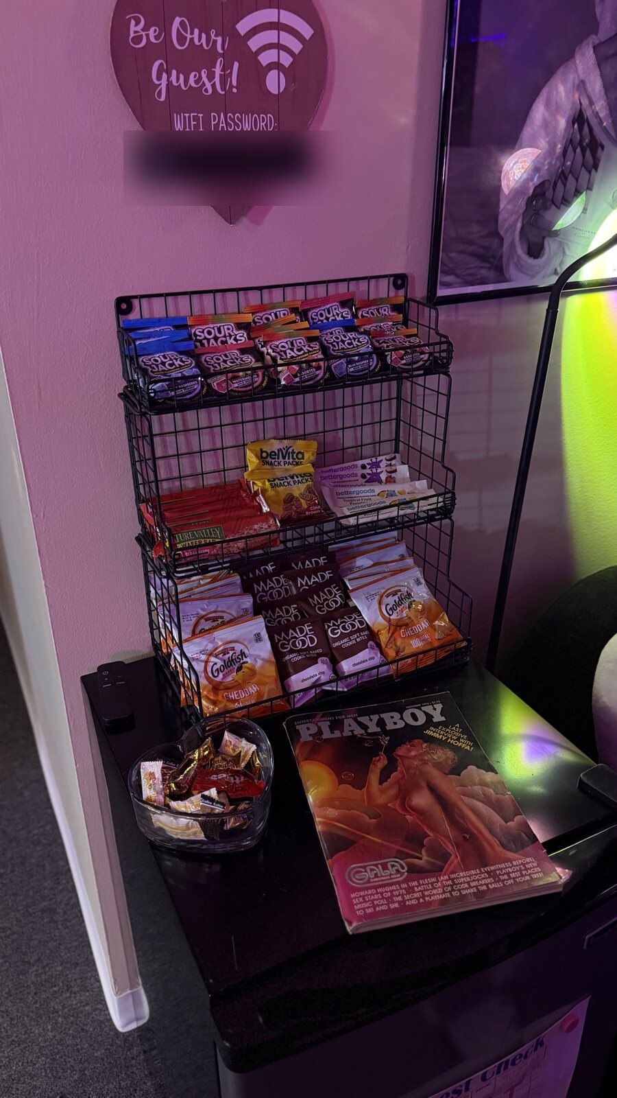 A snack rack under a heart sign that says Be Our Guest